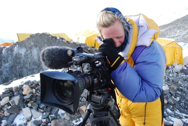 Kirsty filming in a snowy mountain camp